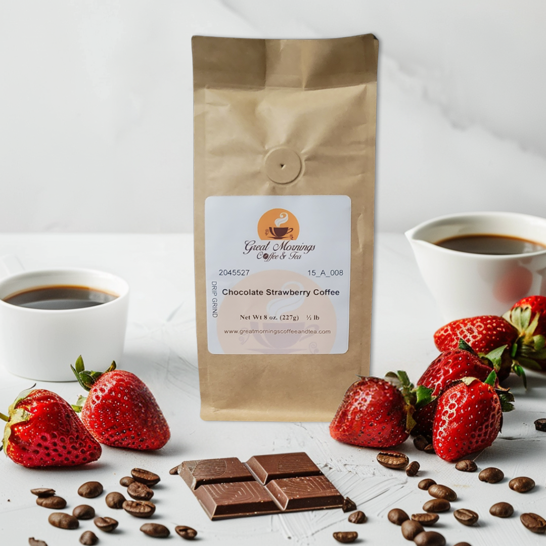 A brown paper bag of "Great Mornings Coffee & Tea" brand's Chocolate Strawberry Coffee is placed in the center. The setup includes fresh strawberries, chocolate pieces, and scattered coffee beans around the bag, with two cups of black coffee in the background. The label on the bag indicates it is a drip grind with a net weight of 8 oz (227g), and the website is www.greatmorningscoffeeandtea.com.